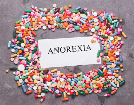 Pills with word ANOREXIA on grunge backgroundの写真素材