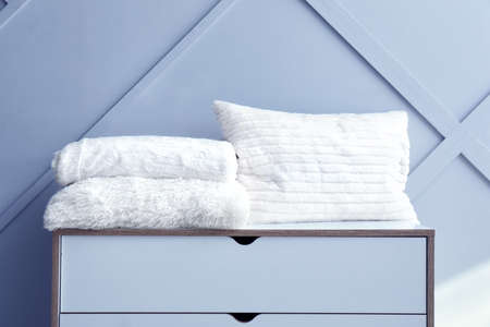 Soft warm plaids and cushion on chest of drawersの写真素材