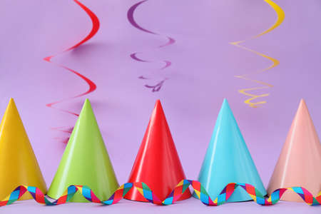 Party hats and decor on color backgroundの写真素材