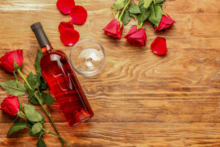 Composition with wine and roses on wooden backgroundの写真素材