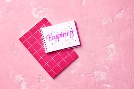 Notebooks with word HAPPINESS on color backgroundの写真素材