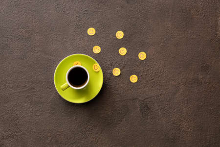 Cup of coffee and paper smiles on dark backgroundの写真素材