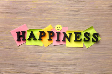 Word HAPPINESS on wooden backgroundの写真素材