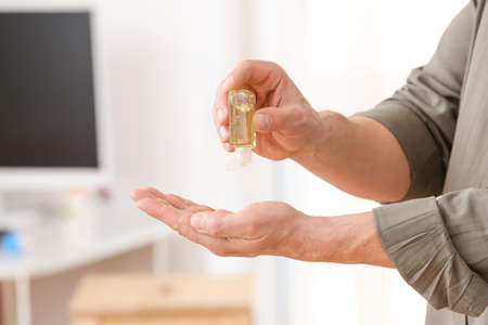 Man using sanitizer at home