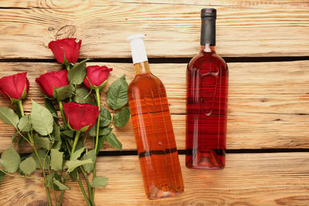 Composition with wine and roses on wooden backgroundの写真素材