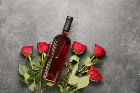 Composition with wine and roses on grunge backgroundの写真素材