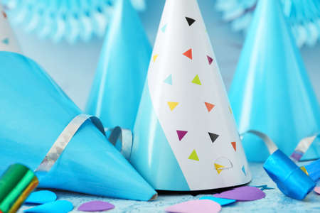 Party hats and decor on color backgroundの写真素材
