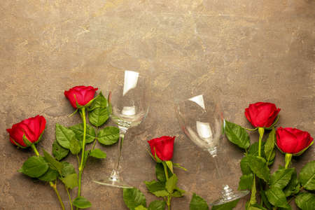 Empty glasses and roses on grunge backgroundの写真素材
