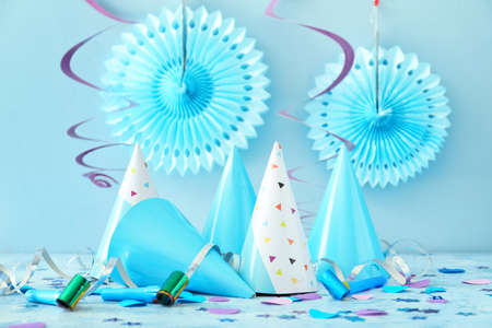 Party hats and decor on color backgroundの写真素材