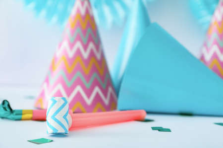 Party hats and decor on light backgroundの写真素材