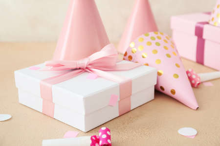 Party hats and gift boxes on light backgroundの写真素材