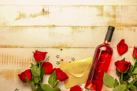 Composition with wine and roses on wooden backgroundの写真素材