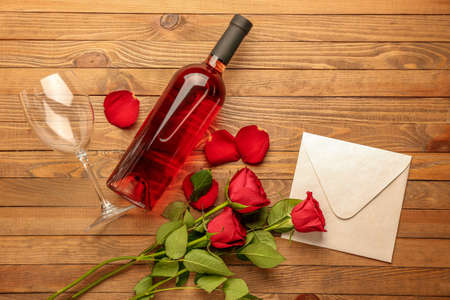 Composition with wine and roses on wooden backgroundの写真素材