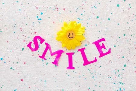 Word SMILE and flower on light backgroundの写真素材