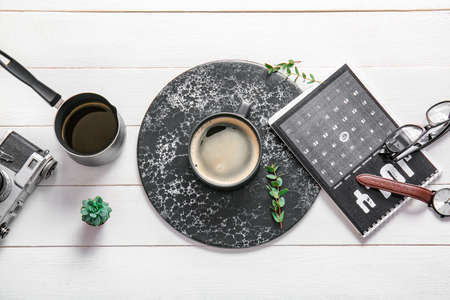Flat lay composition with cup of coffee on white wooden backgroundの写真素材