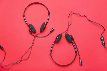 Modern headsets on color backgroundの写真素材