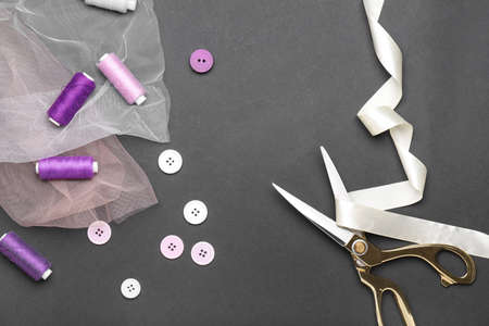 Scissors with sewing items on dark backgroundの写真素材