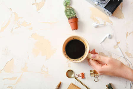 Female hand with cup of coffee on white backgroundの写真素材