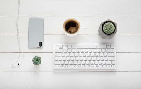 Flat lay composition with cup of coffee on white wooden backgroundの写真素材