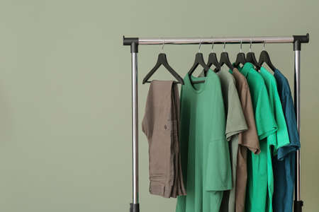 Rack with clothes near color wallの写真素材