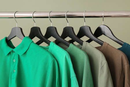 Rack with modern clothes on color backgroundの写真素材