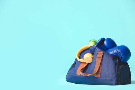 Bag with sportswear and equipment on color backgroundの写真素材