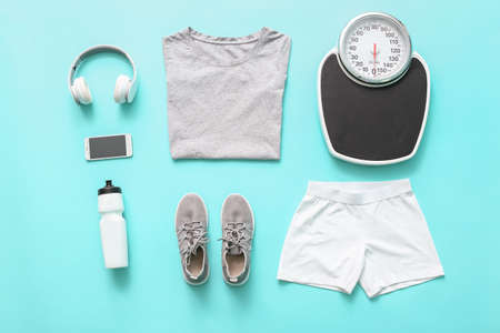 Composition with sportswear and weight scales on color backgroundの写真素材