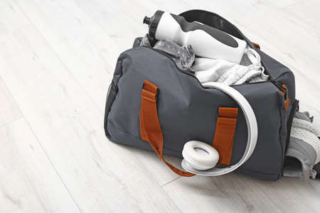 Bag with sportswear and equipment on wooden backgroundの写真素材