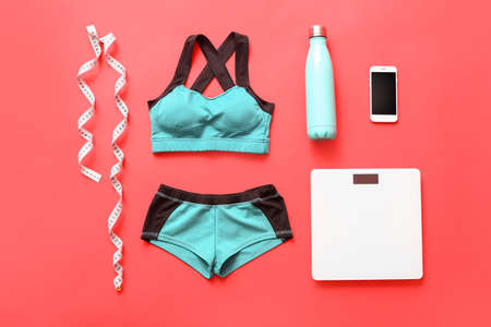 Composition with sportswear and weight scales on color backgroundの写真素材