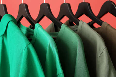 Rack with modern clothes on color background, closeupの写真素材