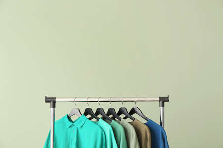 Rack with modern clothes on color backgroundの写真素材