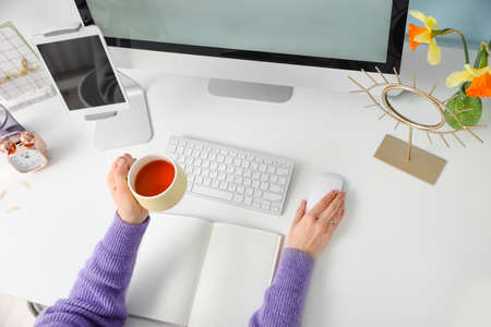 Woman sitting at workplace, top viewの写真素材