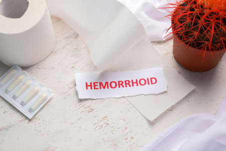 Composition with cactus, toilet paper and word HEMORRHOID on light backgroundの写真素材