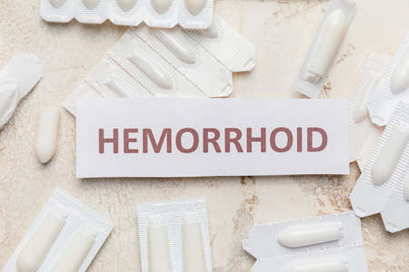 Paper with word HEMORRHOID and suppositories on light backgroundの写真素材