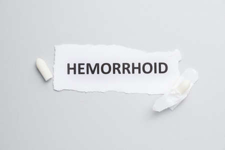 Paper with word HEMORRHOID and suppositories on light backgroundの写真素材