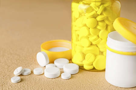 Bottles with pills on color backgroundの写真素材