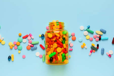 Bottle with pills on color backgroundの写真素材