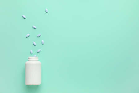 Bottle with pills on color backgroundの写真素材