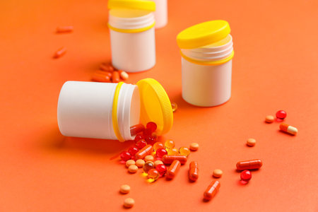 Bottles with pills on color backgroundの写真素材