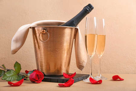 Bucket with ice and champagne on color backgroundの写真素材