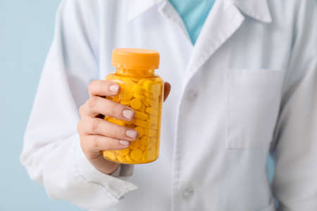 Female doctor with bottle of pills, closeupの写真素材