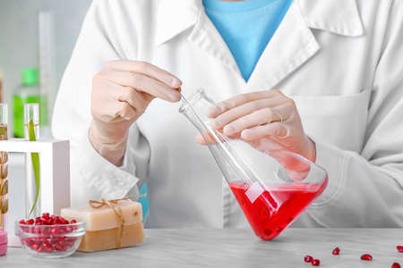 Beautician preparing natural cosmetic in laboratory, closeup