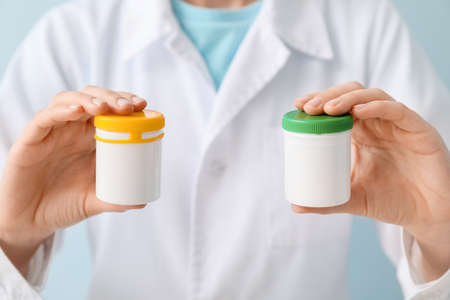 Female doctor with bottles of pills, closeupの写真素材