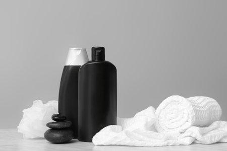 Shower gels, towels and loofah on gray backgroundの写真素材