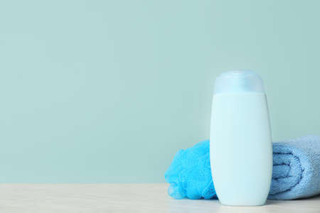 Shower gel, towel and loofah on color backgroundの写真素材