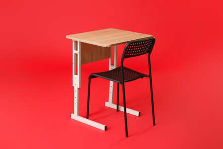 School desk with chair on color backgroundの写真素材