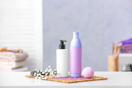 Shower gels on table in bathroomの写真素材