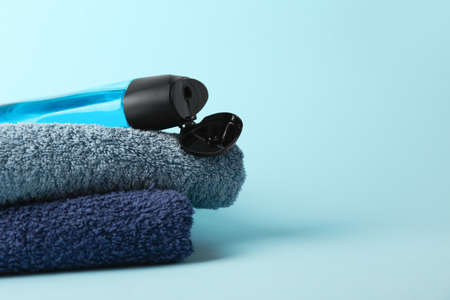 Shower gel and towels on color backgroundの写真素材