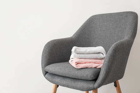 Armchair with warm plaids in roomの写真素材