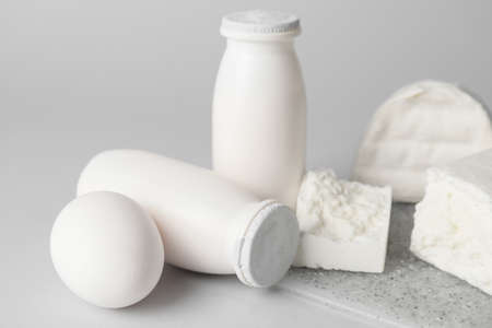 Different dairy products without lactose on gray background